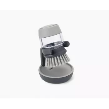 Joseph Joseph Palm Scrub Grey indų plovimo šepetys su integruotu muilo dozatoriumi