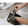 Joseph Joseph Palm Scrub Grey indų plovimo šepetys su integruotu muilo dozatoriumi