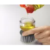Joseph Joseph Palm Scrub Grey indų plovimo šepetys su integruotu muilo dozatoriumi